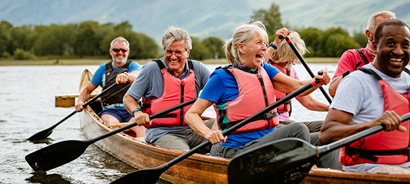 Group of paddlers in a canoe, laughing